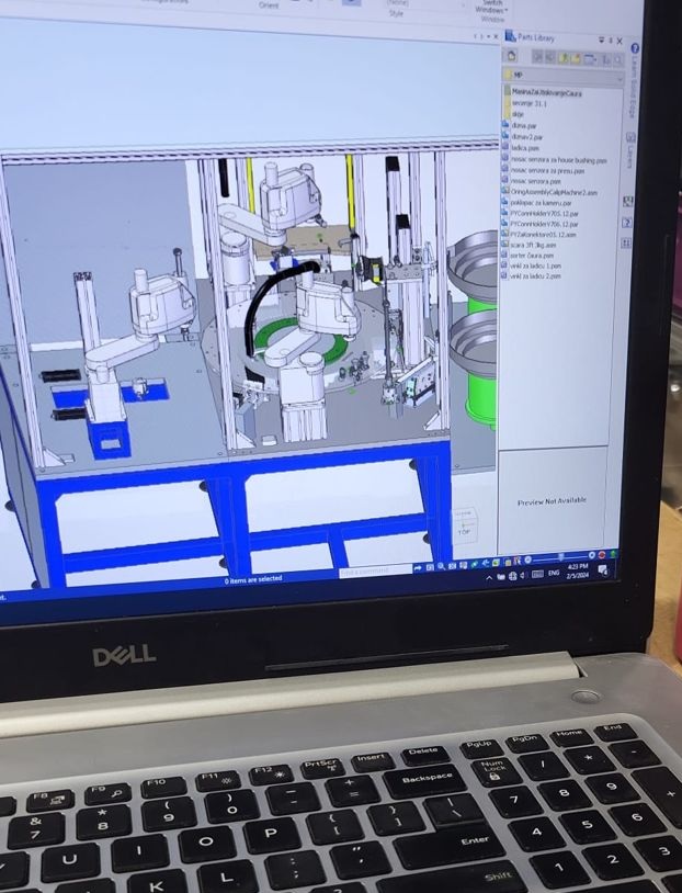 CAD development of automated machine on engineering laptop
